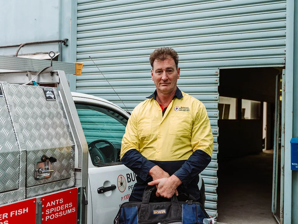 Bug Free technician at an industrial site with the service vehicle